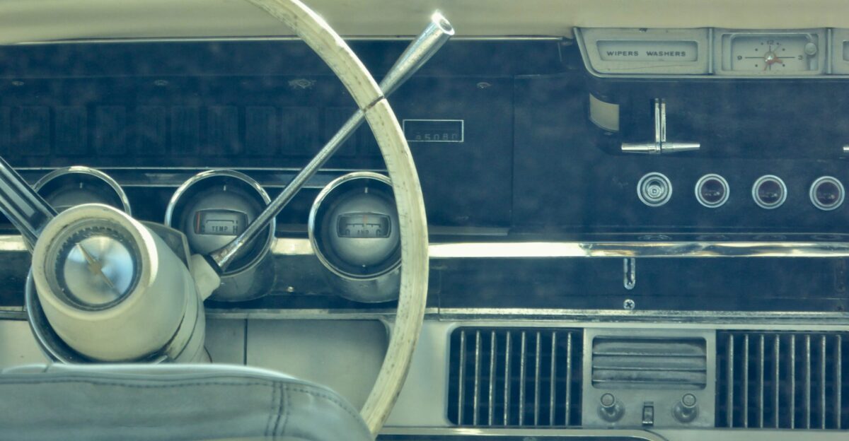 a car dashboard with a steering wheel and a dash board